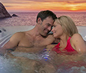 Couple relaxing in spa at sunset